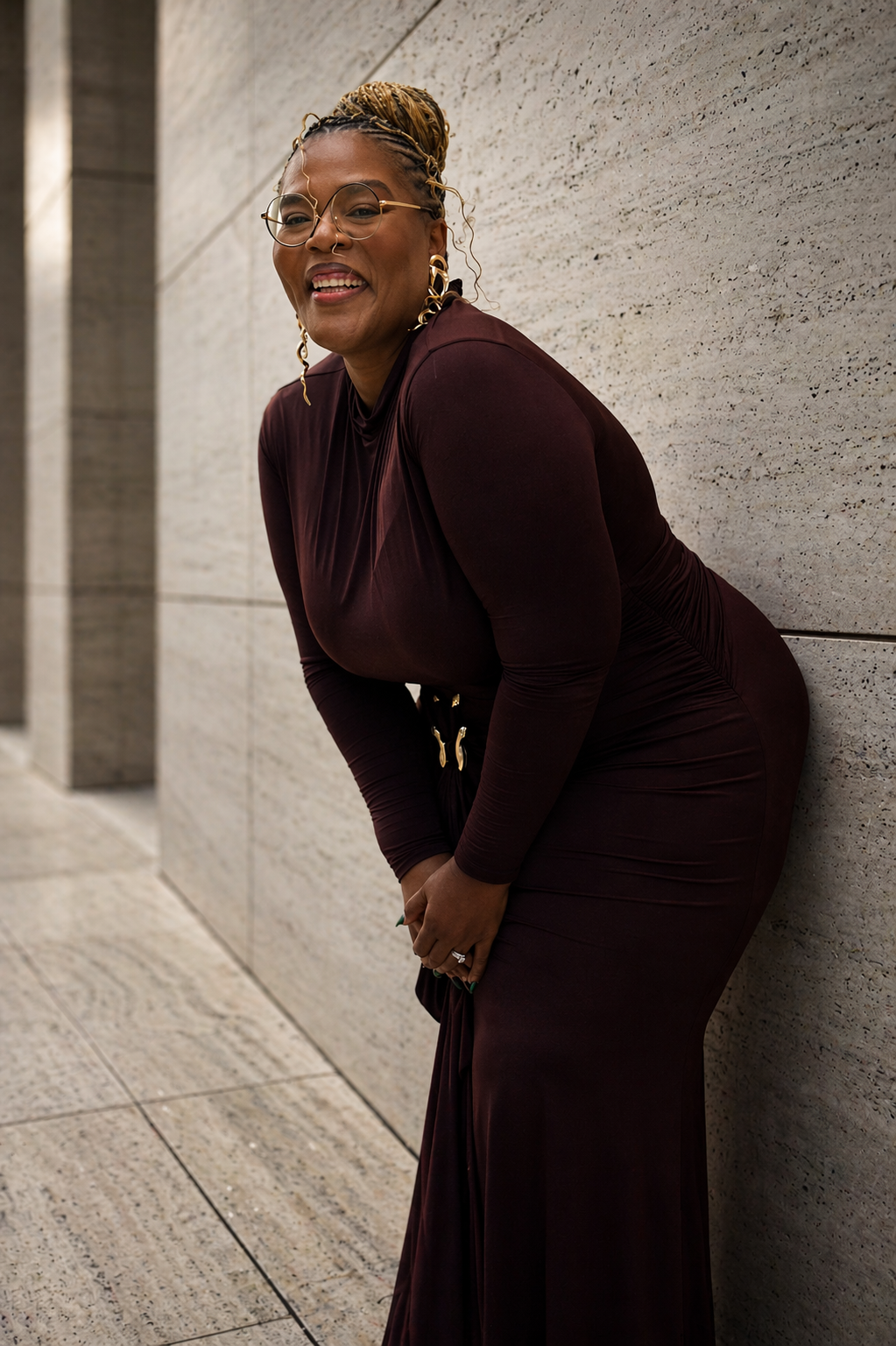 Sunday Rax smiling in a burgundy dress